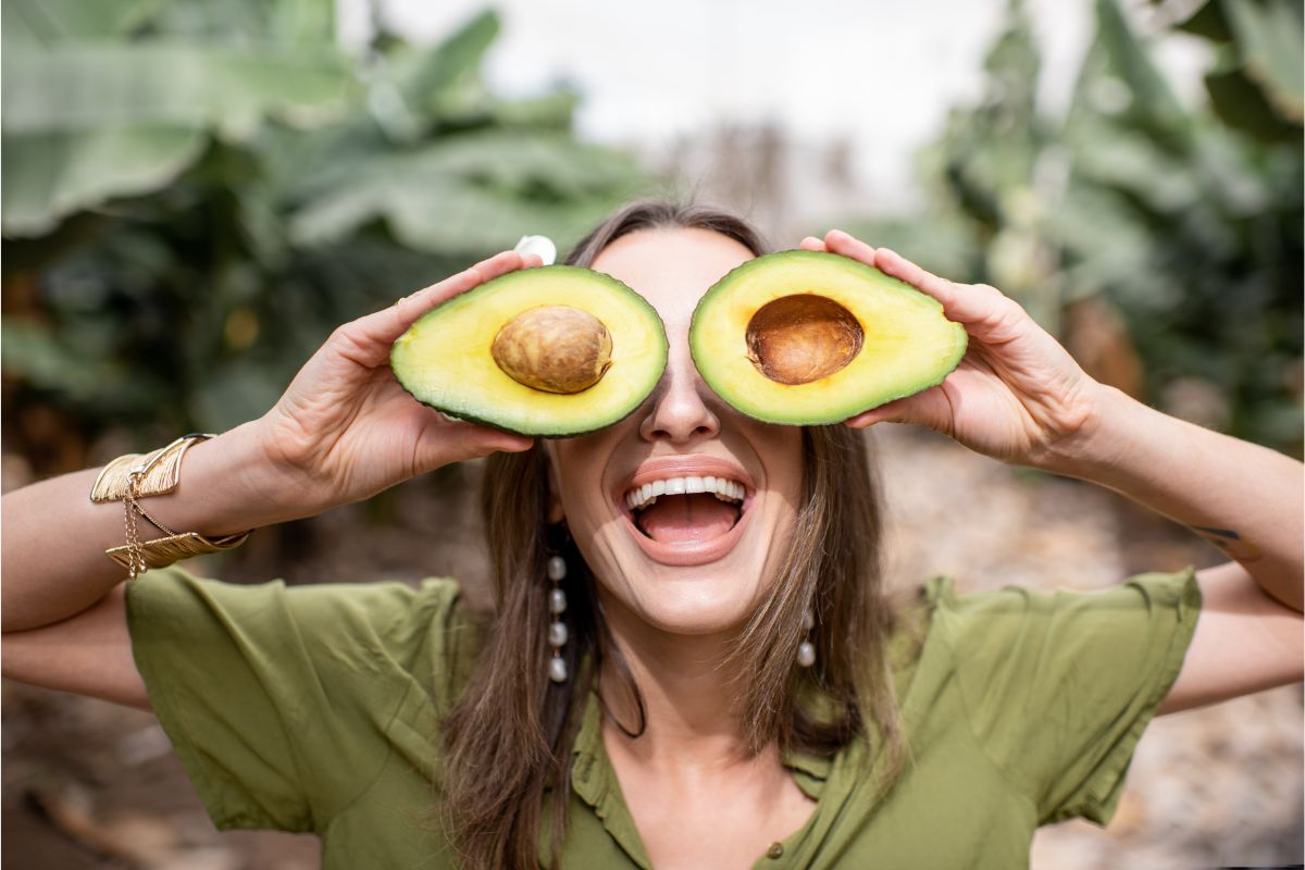 woman holding avocados for eyes