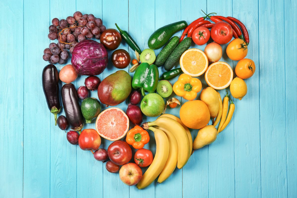 fruits and vegetables arranged in a heart shape