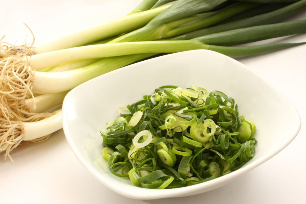 Finely sliced green onions in a bowl. 