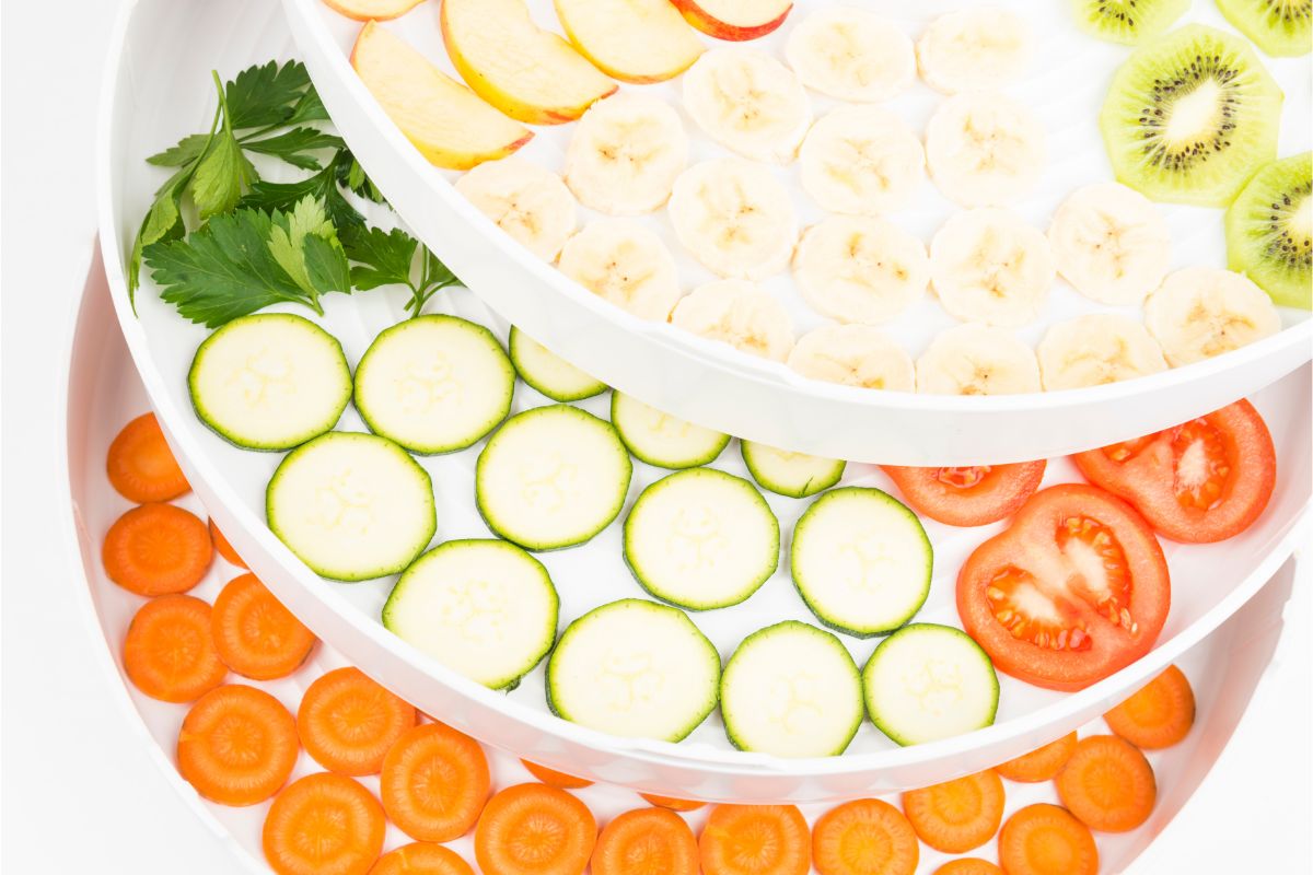 fruits and vegetables on dehydrator trays