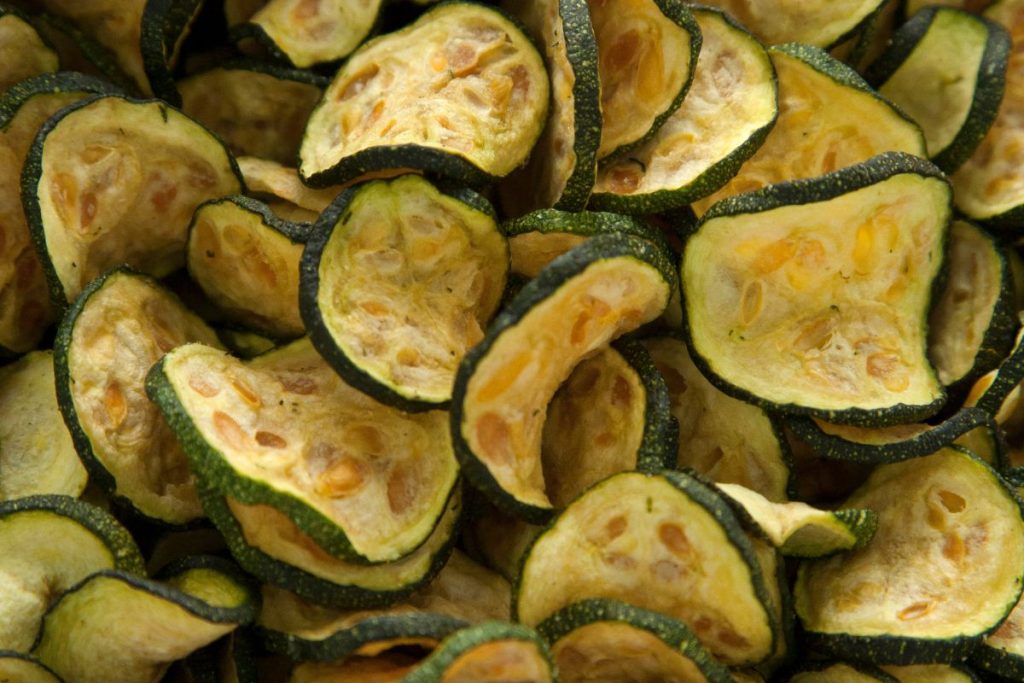 Up close photo of dried cucumber chips with skin and seeds intact