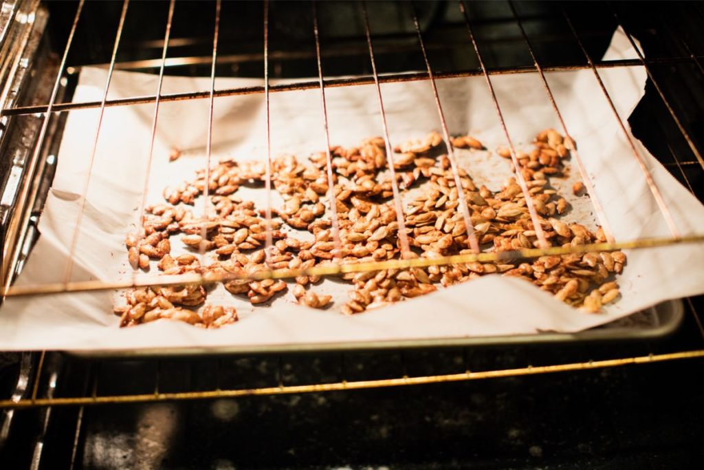 Dark brown oven roasted pumpkin seeds in the oven