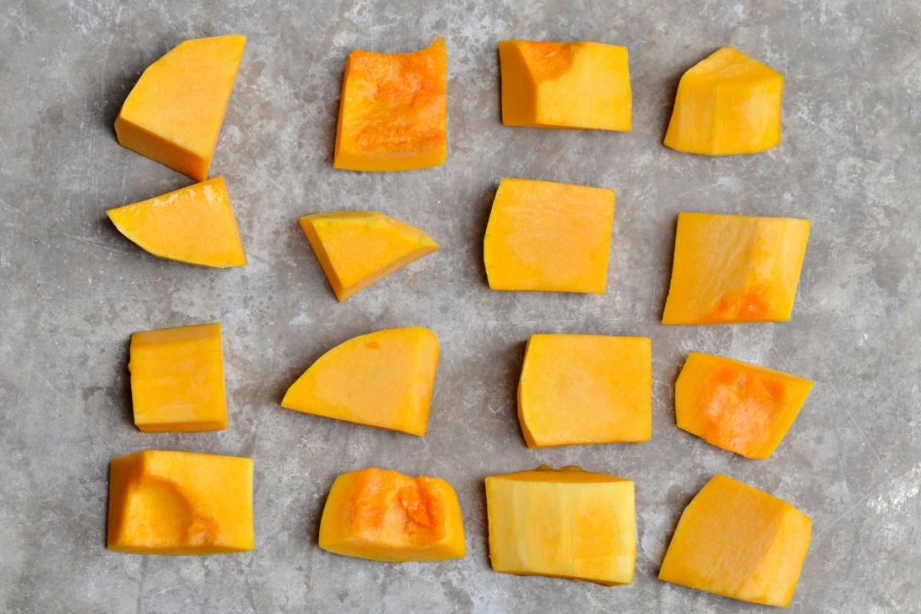 Butternut squash pieces laid out for oven drying