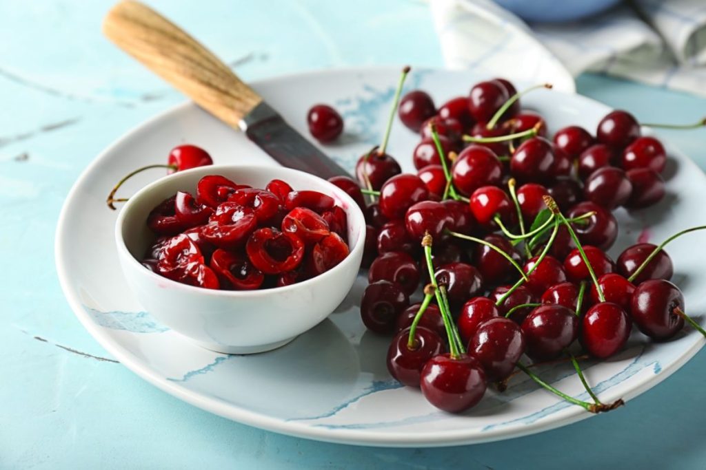 Plate with whole and halved cherries