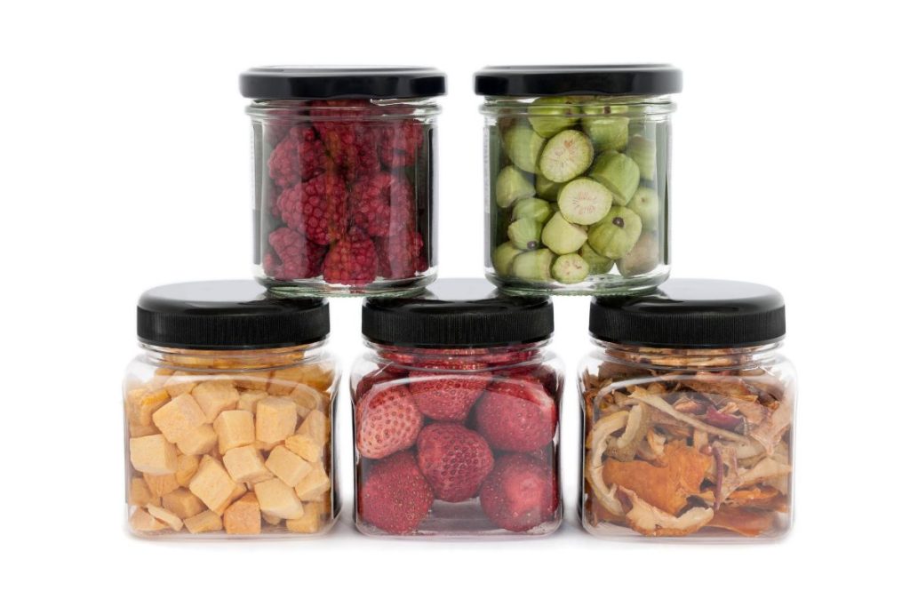 Small canning jars with a different dried fruit in each jar.
