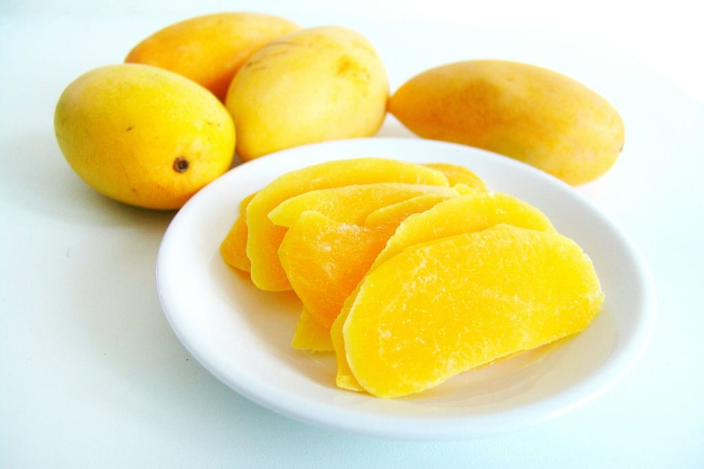 Fresh mangos and sliced dried mango
