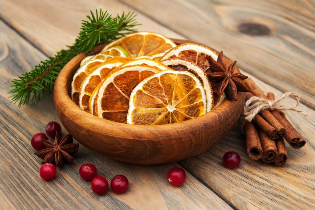Bowl of dried oranges with cinnamon sticks, star anise, and cranberries