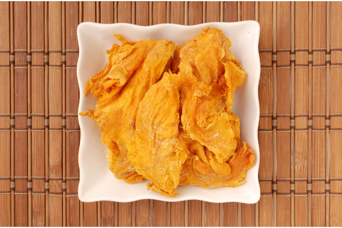 oven dried mango slices on a plate