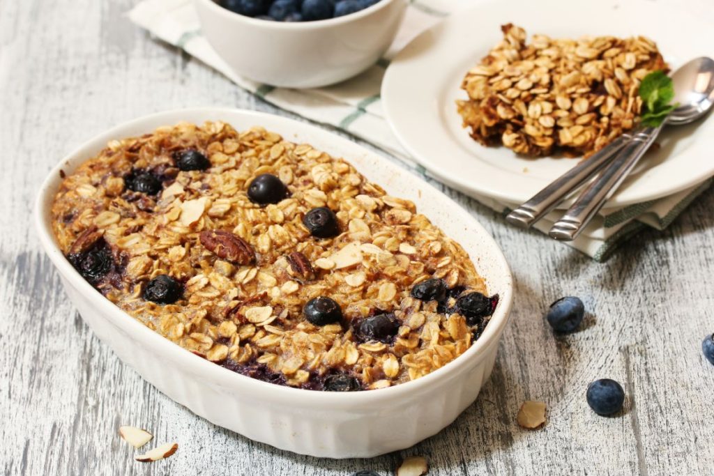 Dish of baked oatmeal with blueberries and nuts