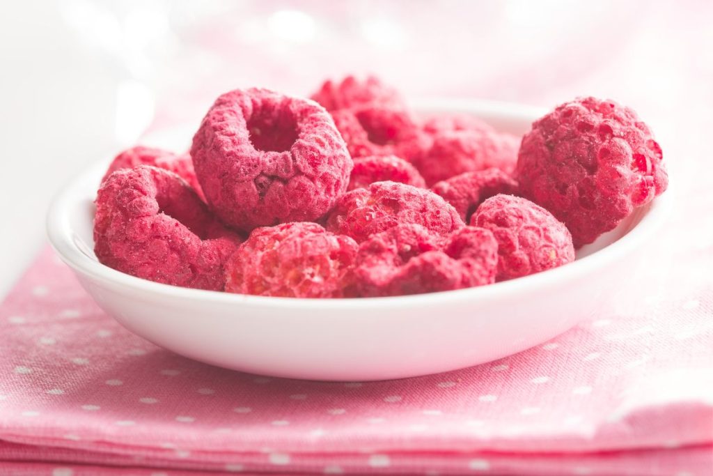 White bowl containing whole freeze-dried raspberries