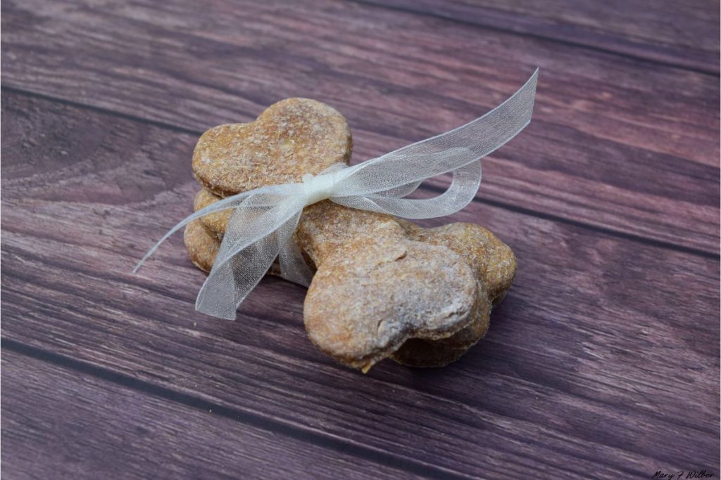 Bone shaped dog biscuits tied with a tulle string on a table