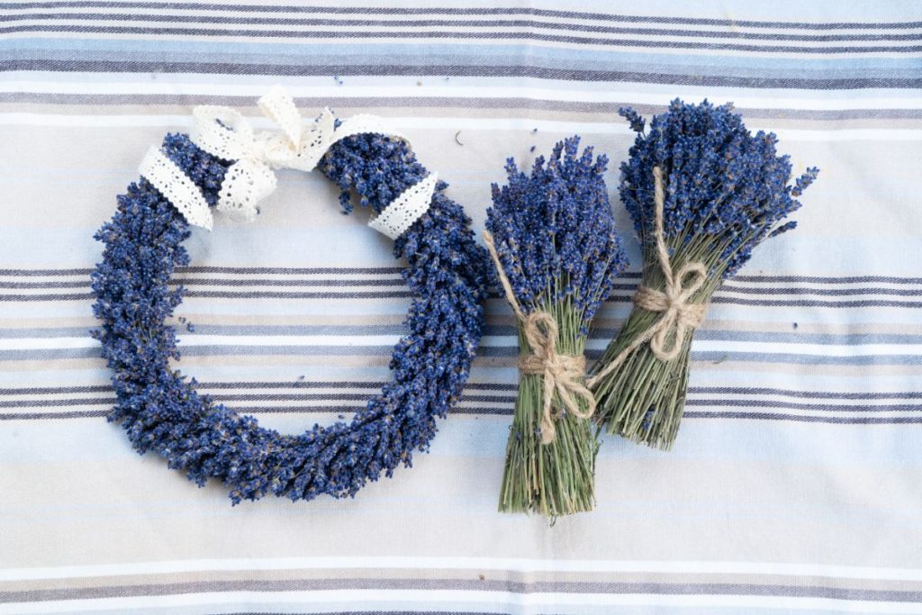 Wreath made from dried lavender next to lavender bouquets