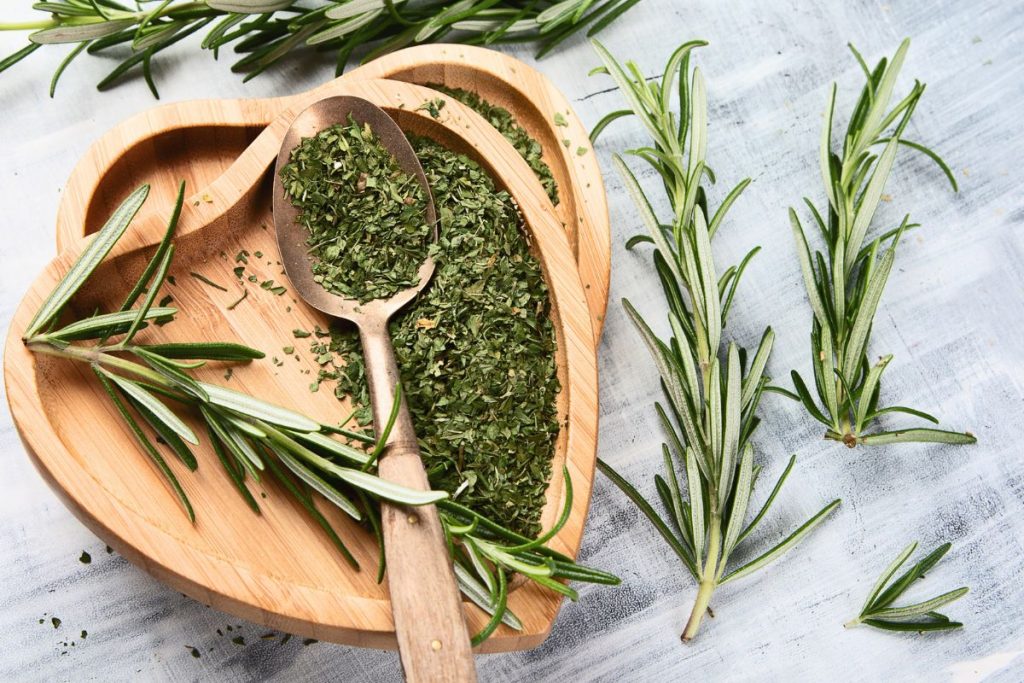 Fresh and dry rosemary in a heart shaped bowl