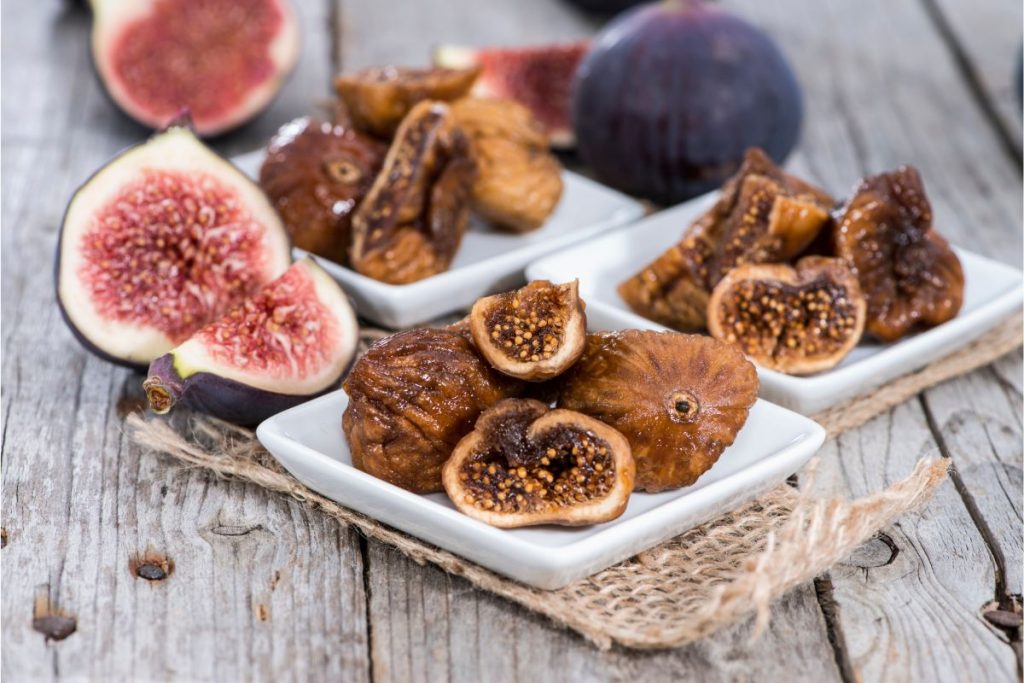 fresh and dried figs side by side on a table