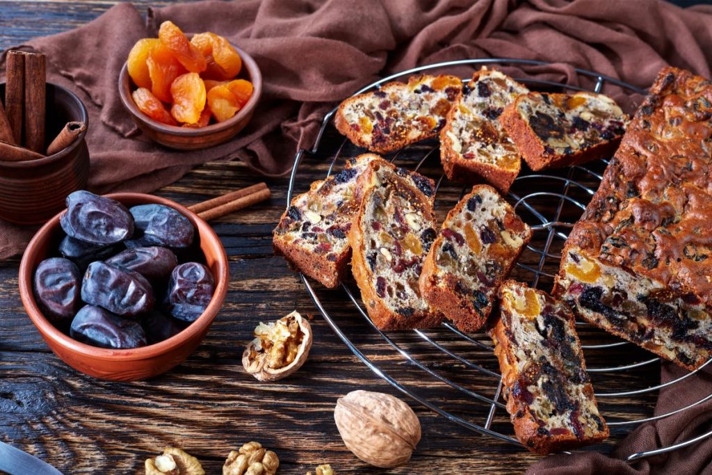 Sliced holiday fruitcake with dried prunes, walnuts, and dried apricots