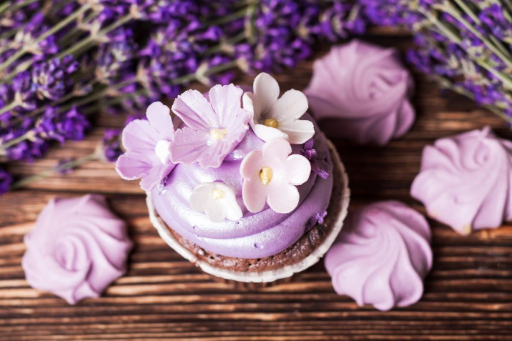 Lavender cupcake with purple frosting and sugar flowers