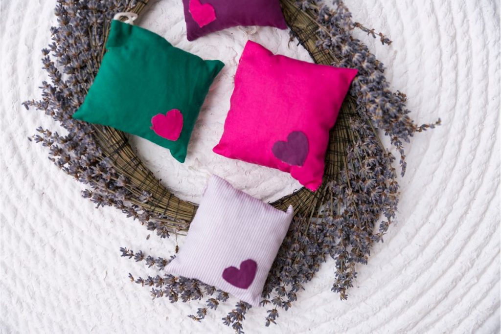 Homemade sachets made from lavender leaves sitting on a dried lavender wreath
