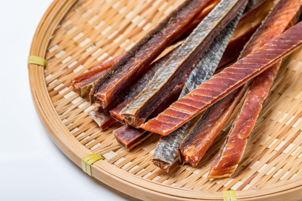 Salmon jerky strips on rattan plate