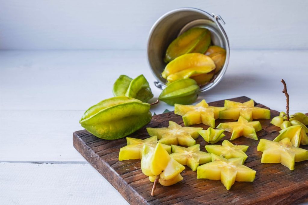 Starfruit sliced on a cutting board
